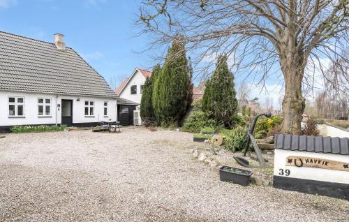 a house with two trees in the yard at 2 Bedroom Nice Apartment In Sydals in Østerby