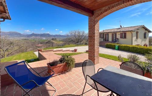a patio with a table and chairs and a house at Stunning Apartment In Gubbio With Wifi in Gubbio