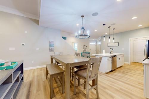 a kitchen and dining room with a wooden table and chairs at Millville by the Sea --- 36515 Calm Water Dr in Millville