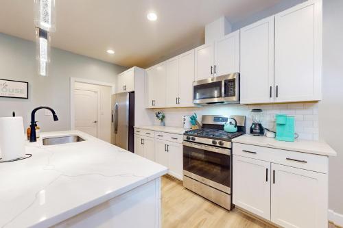 a kitchen with white cabinets and a stove top oven at Millville by the Sea --- 36515 Calm Water Dr in Millville