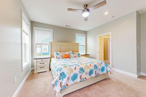 a bedroom with a bed and a ceiling fan at Millville by the Sea --- 36515 Calm Water Dr in Millville