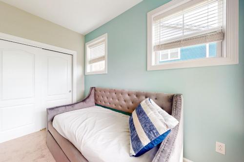 a bedroom with a bed with a pillow on it at Millville by the Sea --- 36515 Calm Water Dr in Millville