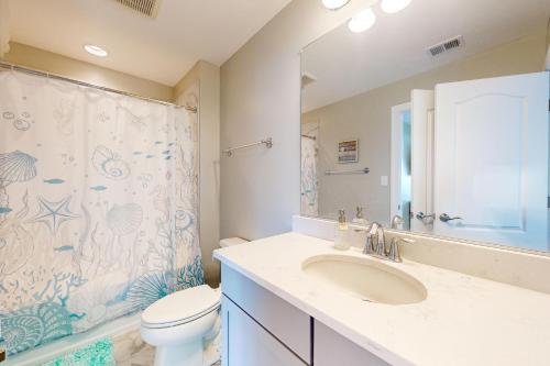 a bathroom with a sink and a toilet and a shower at Millville by the Sea --- 36515 Calm Water Dr in Millville