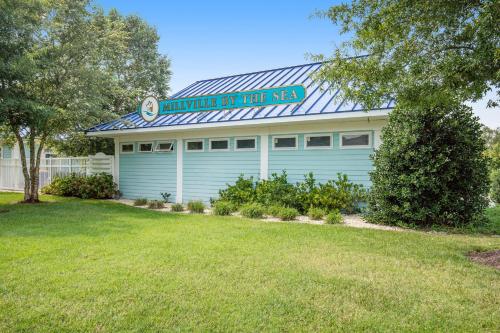 a building with a sign that reads hunter my her reen at Millville by the Sea --- 36515 Calm Water Dr in Millville