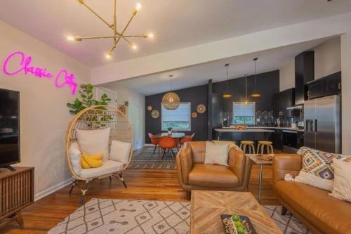 a living room with a couch and chairs and a kitchen at Athens MCM Inn in Athens