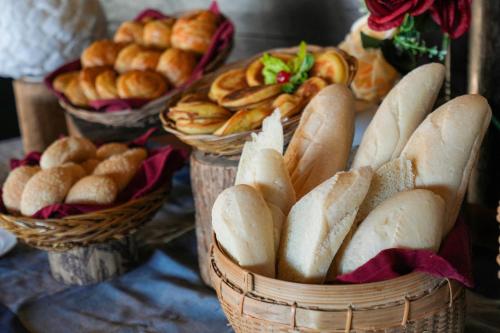 a group of baskets of bread and pastries on a table at Samawa Seaside Resort in Sumbawa Besar