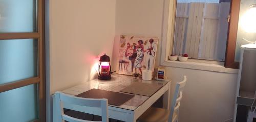 a small table with two chairs and a lamp on it at Miranda House in Jeonju