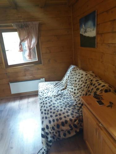 a bedroom with a leopard print bed in a cabin at Holiday house with a parking space Jasenak, Karlovac - 22746 in Ogulin