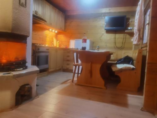 a kitchen with a stove and a table in it at Holiday house with a parking space Jasenak, Karlovac - 22746 in Ogulin