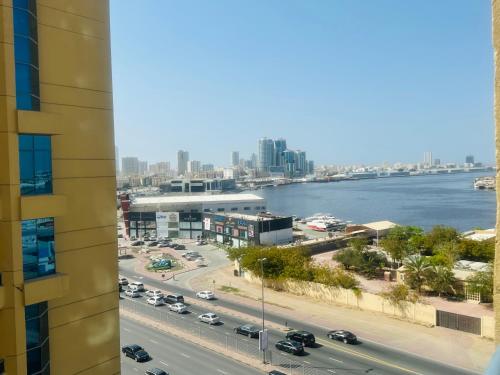 a view of a city and the water from a building at Tranquil Haven:King Bed, Ensuite, Master Bedroom in Ajman 
