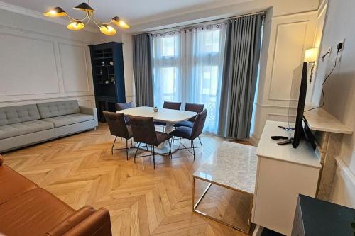a living room with a table and chairs at Apartment London Eye& Big Ben.Walk to China Town.Oxford street in London