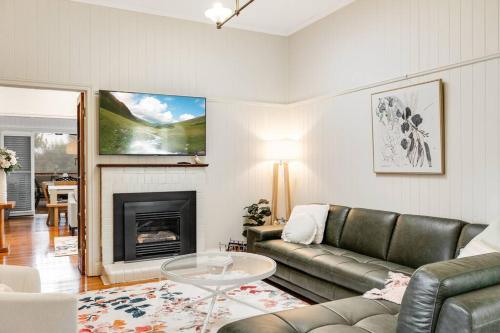 a living room with a couch and a fireplace at Historic Charm & Elegance, Near Grammar! in Toowoomba
