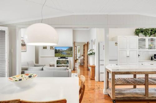 a living room with white furniture and a table at Historic Charm & Elegance, Near Grammar! in Toowoomba