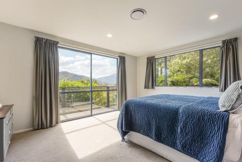 una camera con un letto e una grande finestra di Tepuia Daze - Havelock Holiday Home a Picton