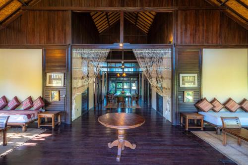 a room with a table and chairs in a building at Samawa Seaside Resort in Sumbawa Besar