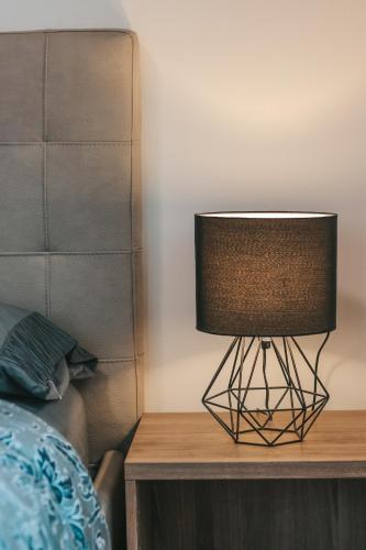 a lamp on a table next to a bed at Agritur il Torchio in Arco