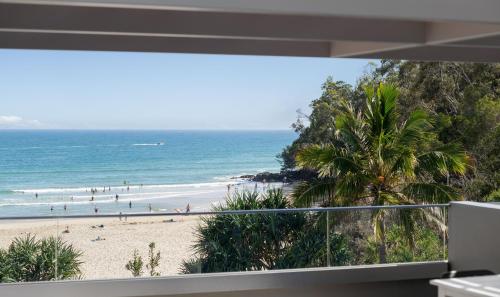 a view of the beach from the balcony of a condo at Netanya Noosa Beachfront Resort in Noosa Heads