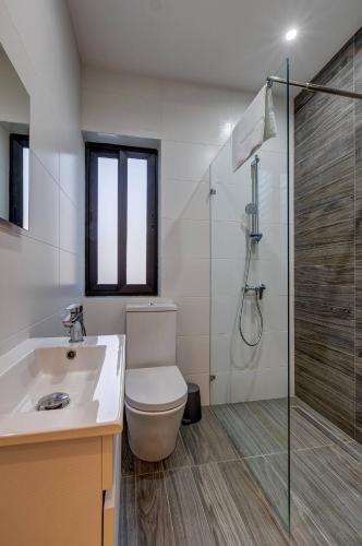 a bathroom with a toilet and a shower and a sink at Stunning 3BED with views Mellieha by Homely in Mellieħa