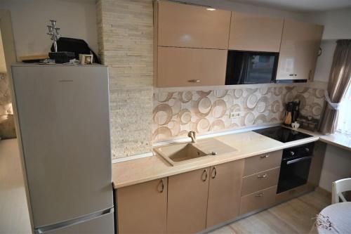 a kitchen with a sink and a refrigerator at Apartament Mangalia in Mangalia
