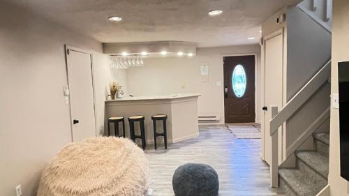 a living room with a counter and a kitchen at Poconos Modern Chalet-Hot Tub-Home Theater-Lake in East Stroudsburg