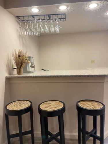 two stools sitting at a bar with a counter at Poconos Modern Chalet-Hot Tub-Home Theater-Lake in East Stroudsburg