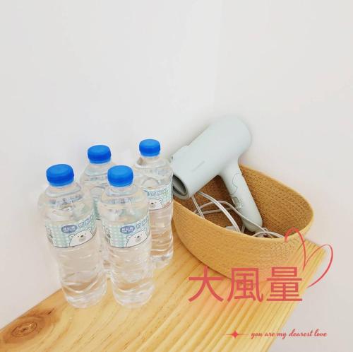 a group of bottles of water sitting on a table at Three meals and four seasons B&B in Magong