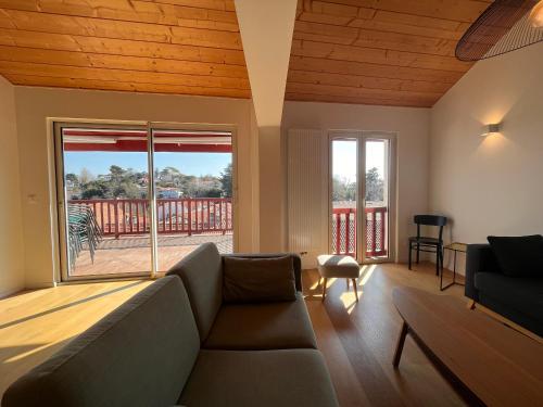 un salon avec un canapé et une grande fenêtre dans l'établissement Maison moderne à 400m de la plage avec terrasses et équipements complets à St-Jean-de-Luz - FR-1-239-878, à Saint-Jean-de-Luz