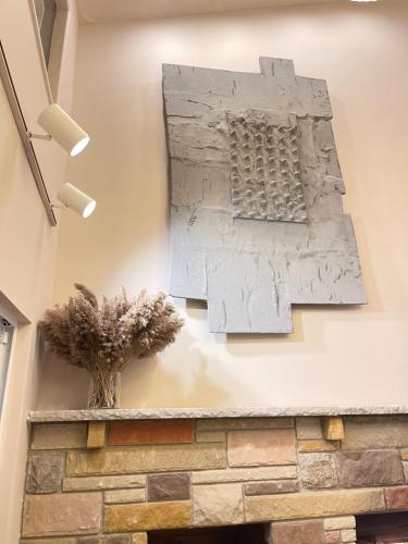 a stone wall with a sculpture on the wall at Poconos Modern Chalet-Hot Tub-Home Theater-Lake in East Stroudsburg