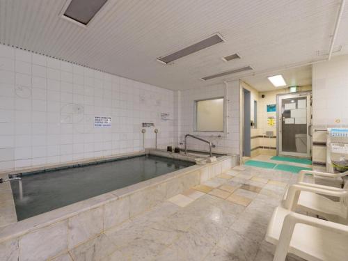 a bathroom with a pool of water in a room at Itabashi Hotel Hilltop in Tokyo