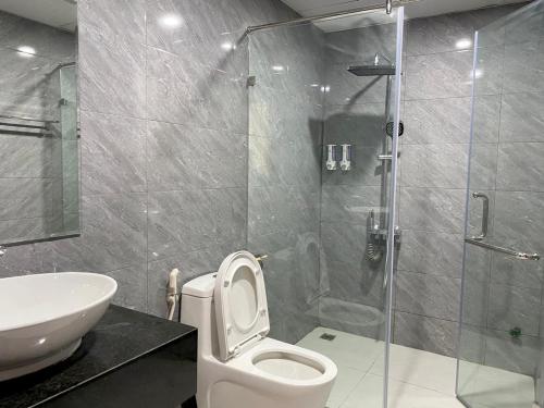 a bathroom with a shower and a toilet and a sink at Nguyễn Quyền Hotel in Hanoi