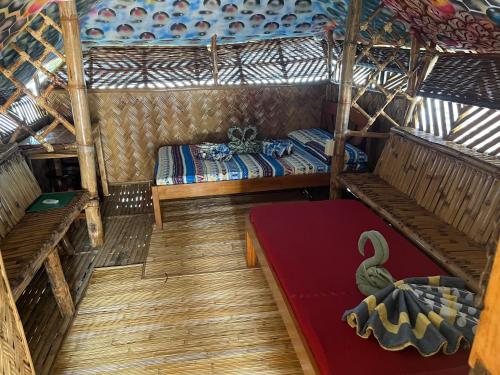 an inside view of a room with a bed at Bamboo Nest Beachfront in Puerto Princesa City