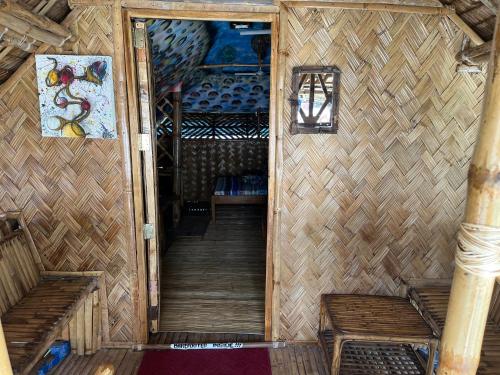 an inside view of a room with two benches and a staircase at Bamboo Nest Beachfront in Puerto Princesa City