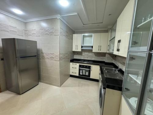 a kitchen with a stainless steel refrigerator and appliances at Family-sized Cosy Apartment in Larache