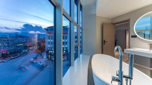 a bathroom with a tub and a view of a city at Holiday Inn Express Shangri-La, an IHG Hotel in Shangri-La