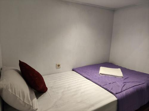 Habitación pequeña con cama y almohada en Ega S Hostel en Nusa Penida