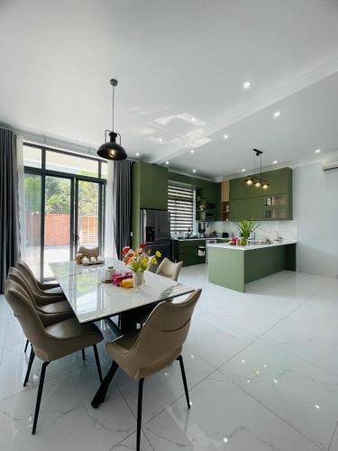 a kitchen and dining room with a table and chairs at Khalid’s House at the East coast in Phu Quoc