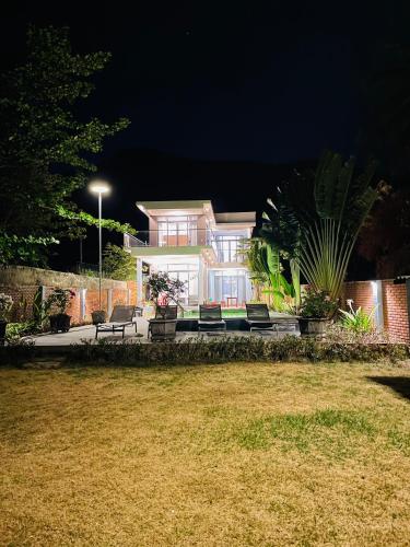 a house at night with chairs and a yard at Khalid’s House at the East coast in Phu Quoc