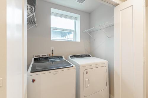 a washer and dryer in a kitchen with a window at Beautifully remodeled Rambler in South Seattle in Seattle