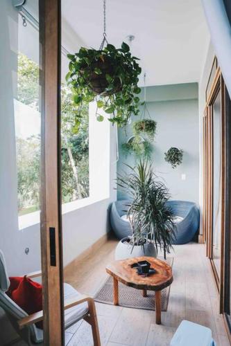 a living room with a table and potted plants at Modern Condo in Casa de Campo in La Romana