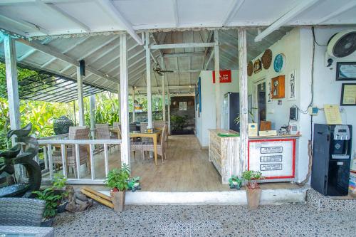 a restaurant with a table and a counter in a building at 221 Garden Cottages in Nusa Lembongan