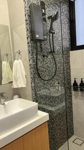 a bathroom with a shower and a sink at Grace Suite @ The Shore KK in Kota Kinabalu