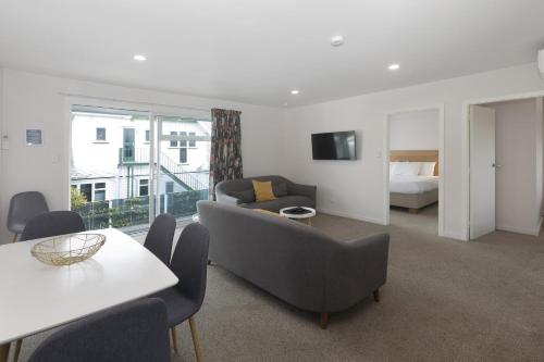 a living room with a couch and a bed at The Adelphi in Christchurch