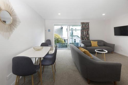 a living room with a couch and a table at The Adelphi in Christchurch