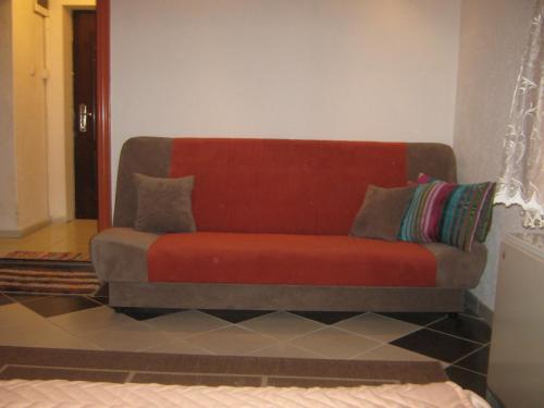 a red couch sitting in a living room at Apartment Vistanova in Vrdnik