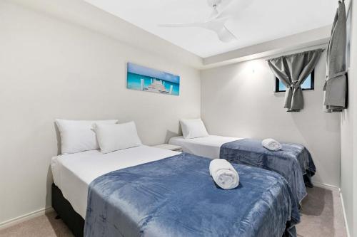 um quarto com duas camas e uma tv nele em Beachfront Jewel em Urangan