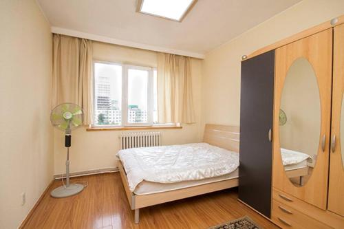 a bedroom with a bed and a window at south of Bayangol Hotel, 1 bedroom apartment 25-58 in Ulaanbaatar