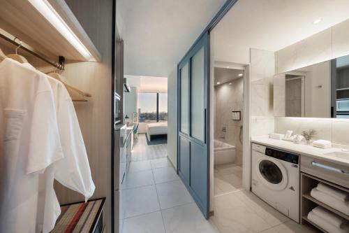 a bathroom with a sink and a washing machine at Hyatt House Tokyo Shibuya in Tokyo