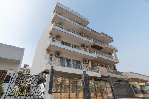 an apartment building with balconies and a fence at Wandr Serpens - Sector 51, Near Artemis hospital, Unitech Cyber Park in Gurgaon