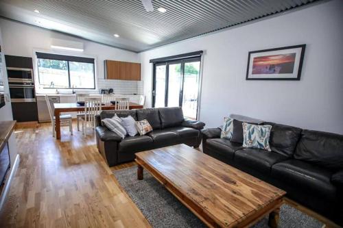 a living room with a couch and a coffee table at Rail View Stay Timboon in Timboon
