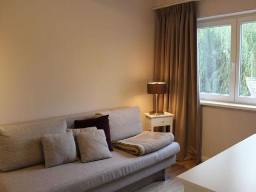 a living room with a couch and a window at Jäschner Villa Luftig in Remptendorf